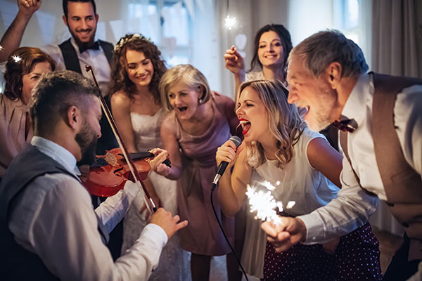 Singer and violin player entertaining at a function.